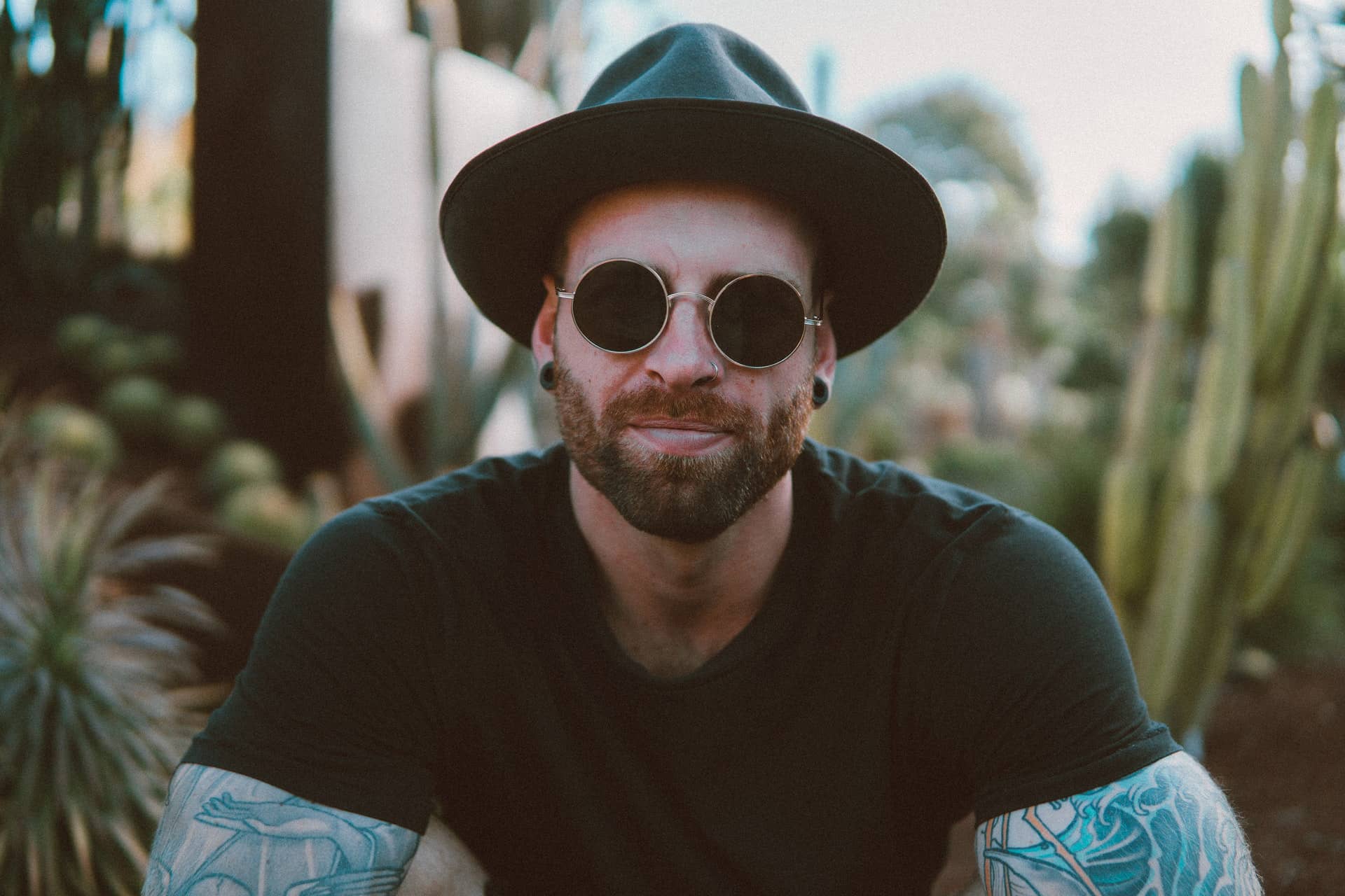 Smiling man in hat and sunglasses